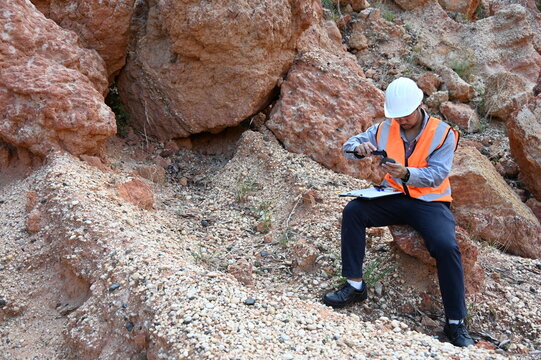 Geologists conducting field inspection and geological survey at an excavation site. Professionals analyzing soil, rock formations and subsurface conditions for mining, construction and exploration pro