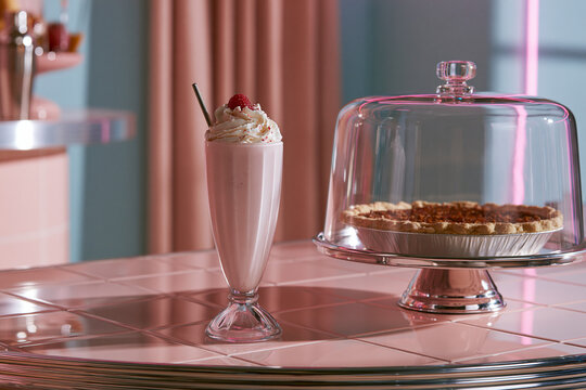 Vintage Dessert Photography: Whipped Cream Strawberry Milkshake with Pie and Pastry Display - Retro Style Cafe Ambience