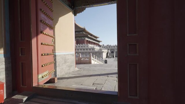 view through huge red gate with view of grand main building of forbidden city beijing grand palace in city center of beijing in winter sunny day,landmark china architecture building
