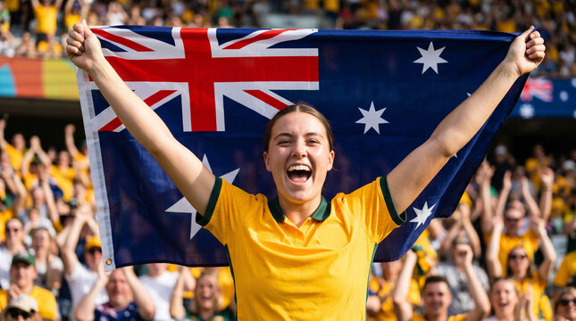 Enthusiastic Australian football fan celebrating with Australia flag at arena