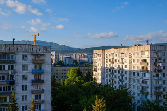 Horizontal landscape photograph capturing typical concrete panel housing buildings during blue hour in the Mukhiani district of Tbilisi
