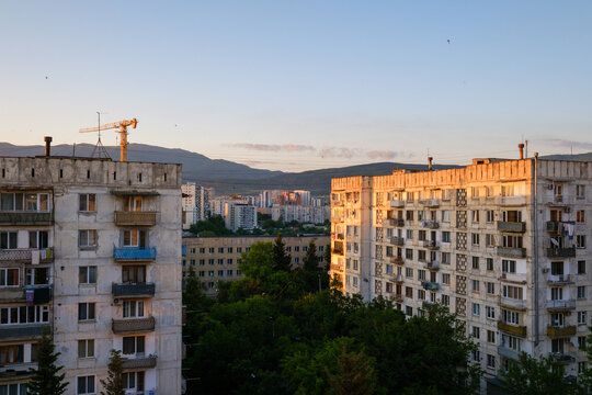 Horizontal landscape photograph capturing typical concrete panel housing buildings during blue hour in the Mukhiani district of Tbilisi