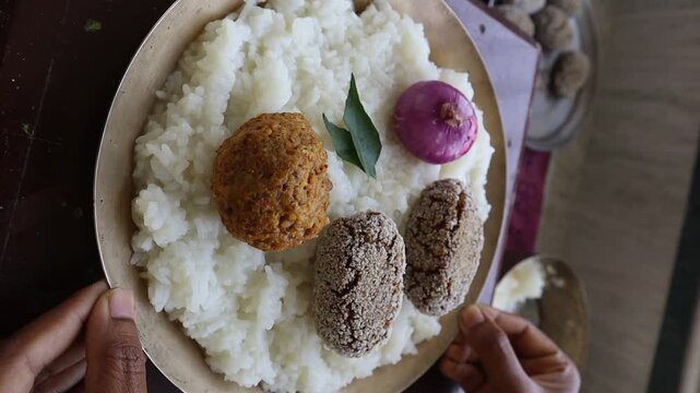Rice thali with dal bhorta, veg cutlet, onion and curry leaves 