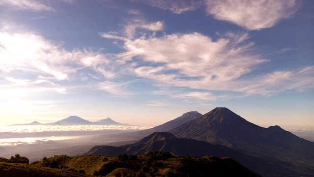 Majestic Sunrise Landscape View Of Mount Sindoro And Mount Sumbing From Prau Mountain In Central Java Indonesia With Dramatic Clouds And Golden Morning Light