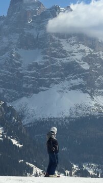 Skier on a snowy slope in Alleghe, Dolomites, Italy. Spectacular mountain scenery in the Dolomiti Superski region. Winter sports, alpine adventure and skiing in the Italian Alps