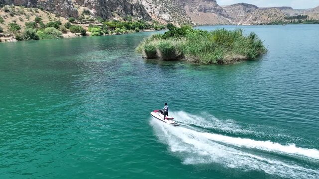 Drone Aerial View of Jet Ski Rider Speeding Across the River, May, 11, 2023, Sanliurfa, Halfeti, Turkiye