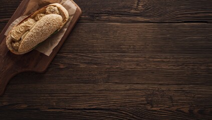 Naklejka premium Overhead rustic view of an appetizing foie gras sandwich served on a wooden table with copy space