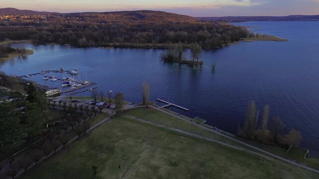 A drone view of the historic town of Angera and Lake Maggiore in Italy. Sunset. 