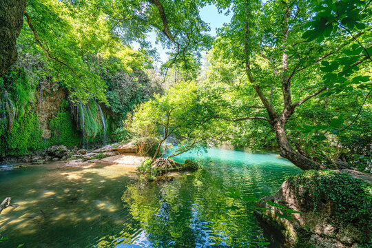 Scenic view of Kursunlu Waterfall and emerald water pond in Antalya nature park, Turkey.