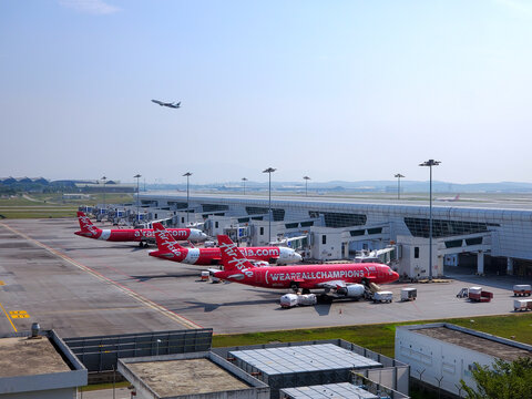 General view of several AirAsia commercial passenger airplanes parked at the gates of Kuala Lumpur International Airport (KLIA) Terminal 2 on January 15, 2026 in Sepang, Malaysia.