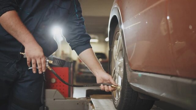 Mechanic Checking Car Tire Pressure In Auto Service Garage