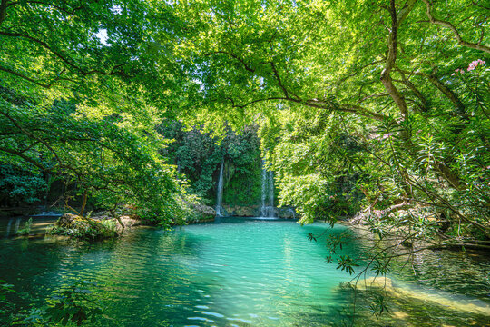 Scenic view of Kursunlu Waterfall and emerald water pond in Antalya nature park, Turkey.