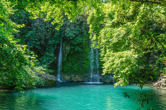 Scenic view of Kursunlu Waterfall and emerald water pond in Antalya nature park, Turkey.