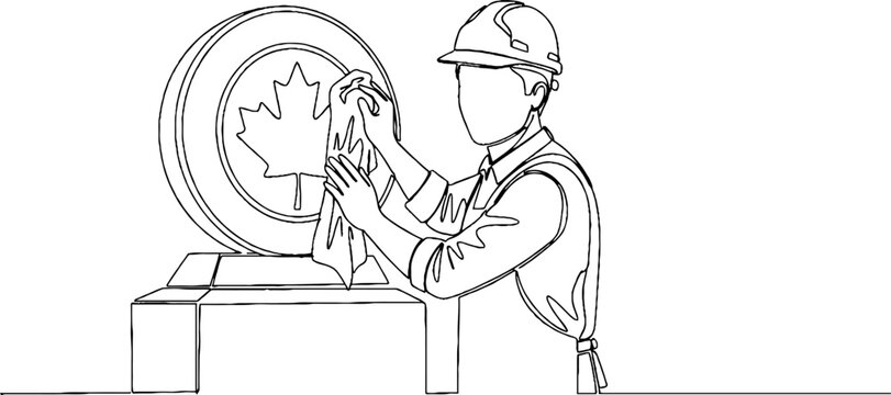 Construction worker polishing large maple leaf emblem carefully.