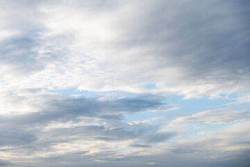 Fototapeta premium Beautiful blue sky filled with textured white clouds on a bright sunny day