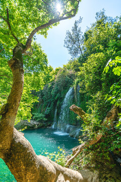 Scenic view of Kursunlu Waterfall and emerald water pond in Antalya nature park, Turkey.
