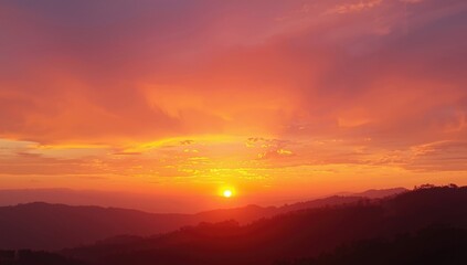 Obraz premium Vivid sunset sky casting golden beams and colorful clouds across a summer horizon