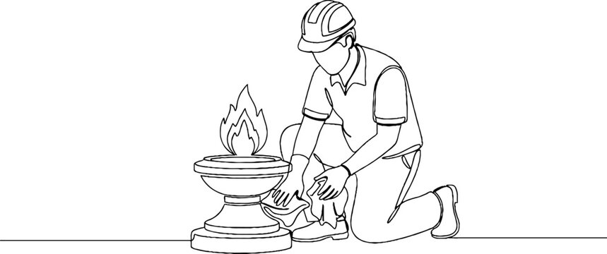 Worker repairing industrial brazier with protective gear.