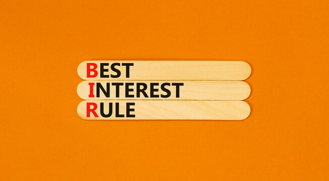 BIR best interest rule symbol. Concept words BIR best interest rule on beautiful wooden sticks. Beautiful orange background. Business BIR best interest rule concept. Copy space.