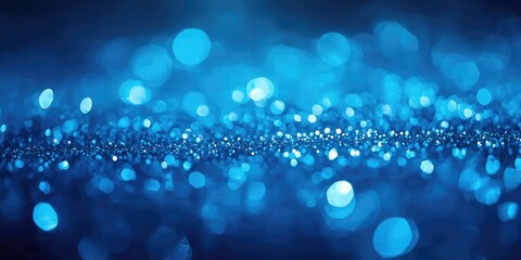 Fototapeta premium Soft bokeh effect illuminating blue glitter particles and shimmering festive sparkles in an elegant underwater magical backdrop