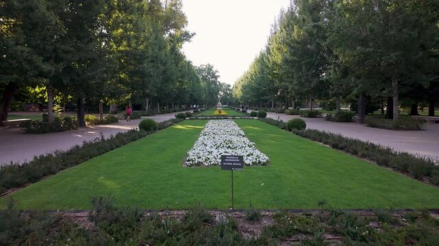 Gardens of the Retiro Park, with colorful flowers and lots of vegetation, at dawn in spring, Madrid.