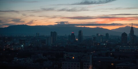 Fototapeta premium Urban landscape featuring a twilight mountain view