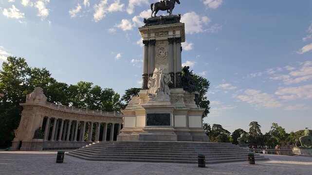 Colonnade in the pond of the Retiro Park where tourists gather to rest in Madrid.