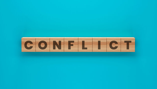 Conflict Wooden Blocks: The word CONFLICT is spelled out on small wooden blocks arranged in a line against a vibrant teal background, symbolizing disagreement and tension.