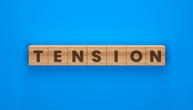 Wooden blocks spelling out TENSION on a vibrant blue background, representing a state of mental strain and unease.