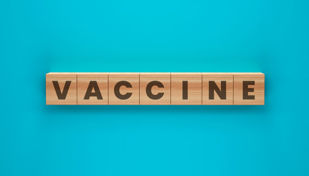 VACCINE spelled out with wooden blocks on a bright blue background. This image evokes a sense of scientific progress and public health initiatives.