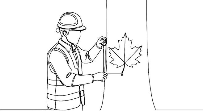 Construction worker measuring large maple leaf outline.