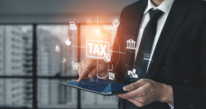 Businessman in Suit Using Tablet to Manage Tax Information with Digital Icons and Graphs in Modern Office Environment Sigmoid