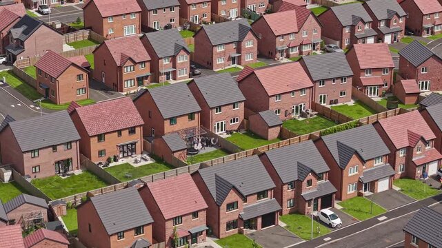 Rows of small new build houses show residential housing development properties, England