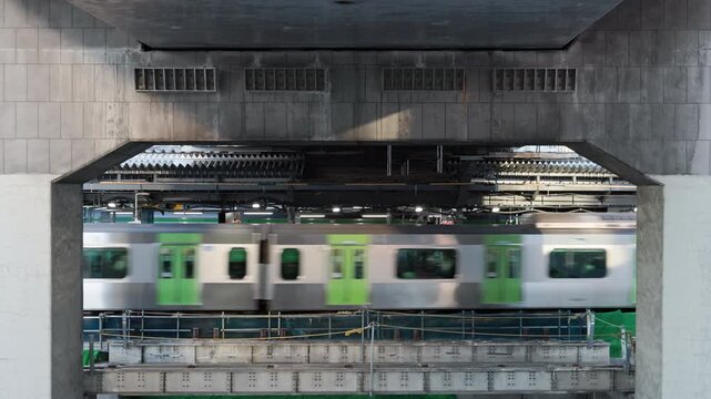 Tokyo Scene  :  Train Arrives on the Station Platform Visible Between the Expressway Supports, as a Complex Layered Urban Structure Is Exposed  |  Yamanote Line, Shibuya Station, Tokyo, Japan