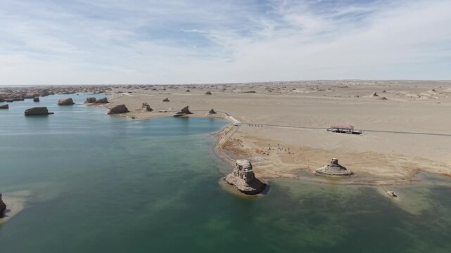 Aerial Flight Above Desert Lake and Yardang Landforms
