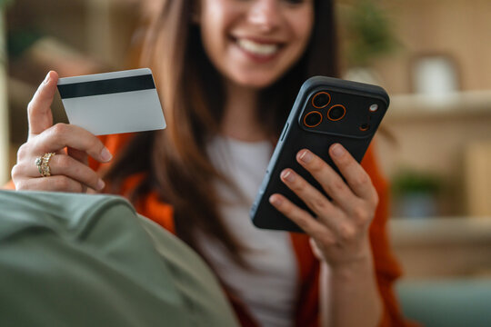 Woman shopping online with credit card and smart phone