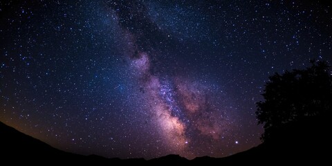 Obraz premium vivid milky way stars shining bright in a pitch black night