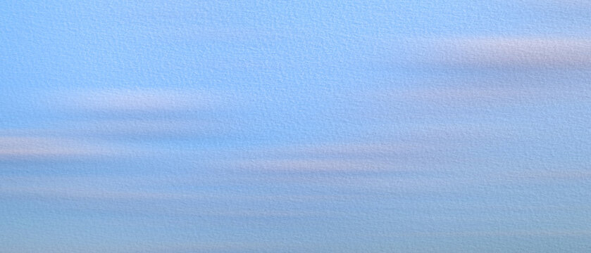 Abstract painting of delicate blue sky on textured paper as background. Light, barely noticeable clouds float gently across  horizon. calm, serene atmosphere soft lighting. tranquil backgrounds