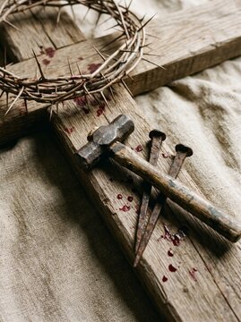 Symbolic representation of sacrifice crown of thorns and hammer on cross