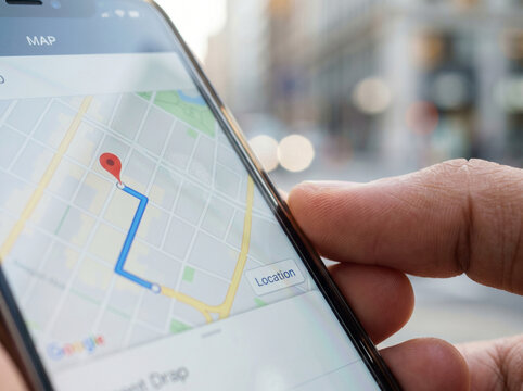 Person holding smartphone with map navigation route logistics