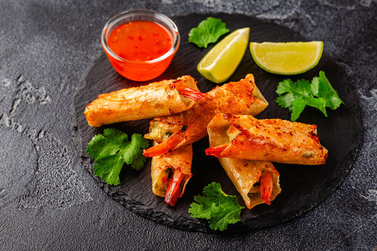 Fried spring rolls with shrimps served with sauce and lime