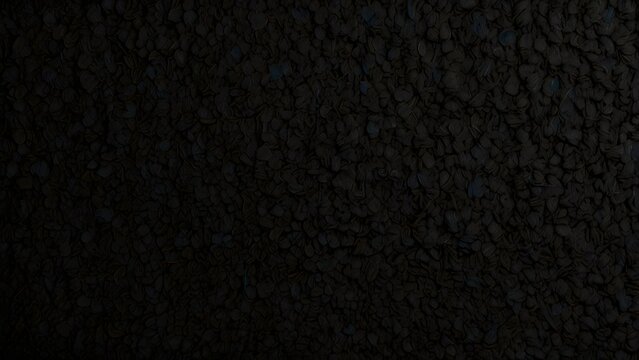 Dark abstract textured background. Close-up of rough, uneven black surface with subtle light variations.