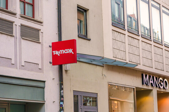 Augsburg, Germany - May 25, 2026: exterior view of tk maxx and mango store signs on a building.