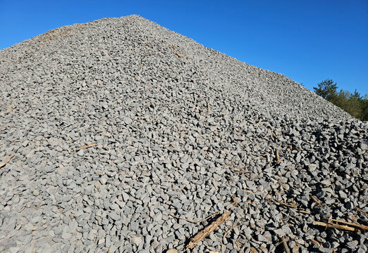 Large pile of gravel at construction site in sunny weather