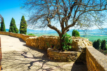 Naklejka premium Panoramic view of the hills and countryside surrounding the village of Pienza (Tuscany village, Italy) seen from its medieval fortified walls, during early summertime.