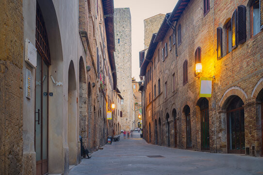 View of and old alley at the dusk in San Gimignano, medieval village of Tuscany (Province of Siena, Italy); is world famous for its renaissance monuments and white wine production (named "Vernaccia").