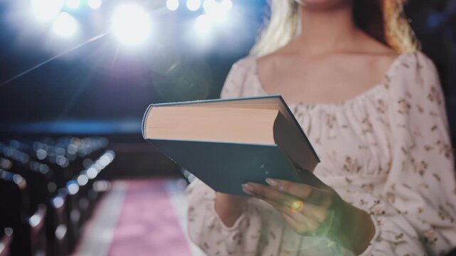 Actress Holding Book and Reading Script on Stage. Poetry and Theater Concept