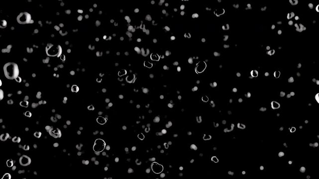 Multiple translucent bubbles of varying size rising against pure black background captured from front angle in wide horizontal frame