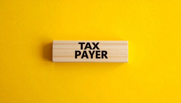 Wooden Block with the Word &ldquo;TAX PAYER&rdquo; on Bright Yellow Background