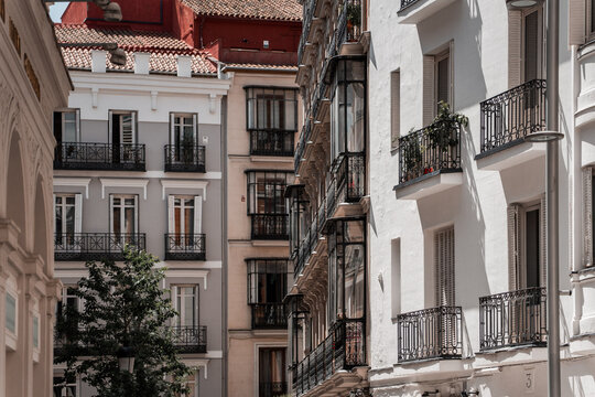 Architecture of the city center of Madrid. Alley and narrow roads with Spanish balconies and design.
